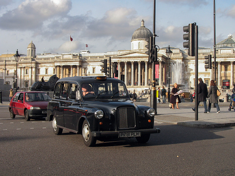 London, United Kingdom - 10 November, 2006: Austin/LTI FX4 (London Taxi Company) taxi vehicle driving on a street next to Trafalgar Square. This vehicle was the most popular taxi car in UK.