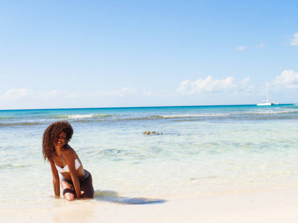 istock Young curly woman waiting for the waves to come 1282756084
