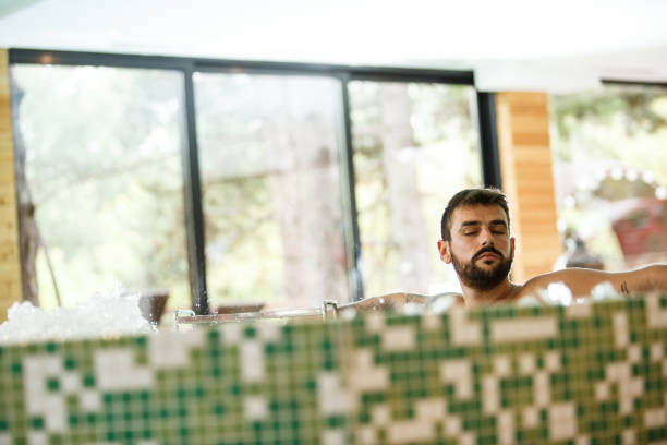 istock Young man relaxing in a hot tub 1282756144