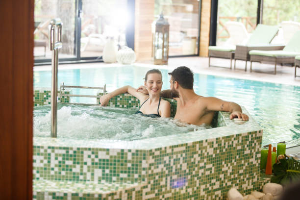 istock Young couple relaxing it the hot tub 1282756151