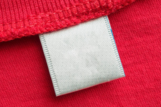 istock White blank laundry care clothes label on red cotton shirt background 1282756290