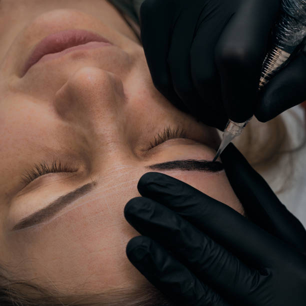 istock Permanent eyebrow makeup procedure. Eyebrow tattooing, process. The use of tools by a master for permanent eyebrow makeup. 1282756761