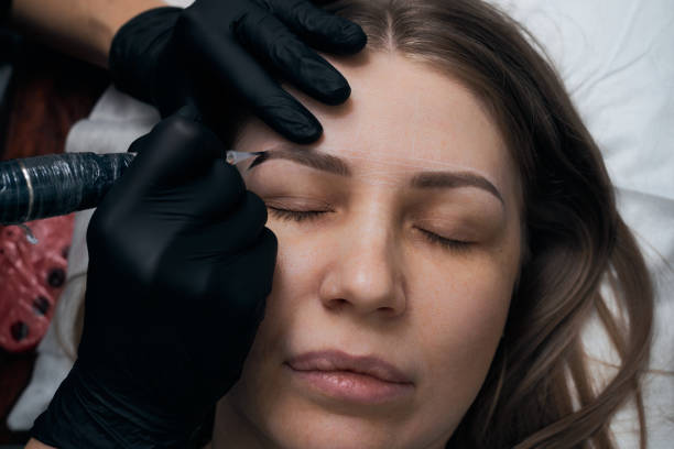 istock Permanent eyebrow makeup procedure. Eyebrow tattooing, process. The use of tools by a master for permanent eyebrow makeup. 1282756768