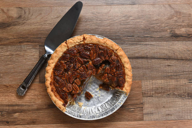 istock A Thanksgiving holiday pecan pie in tin with piece missing. 1282757791