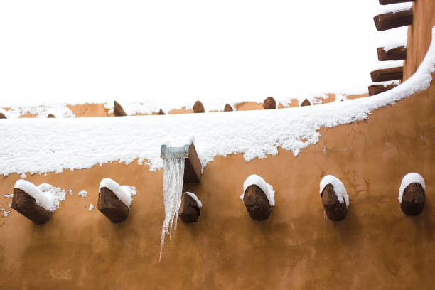 Santa Fe, NM: Adobe walls in a snowstorm, with hanging icicle. Copy space available.