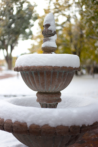 Santa Fe, NM: Mexican stone fountain in a snowstorm.