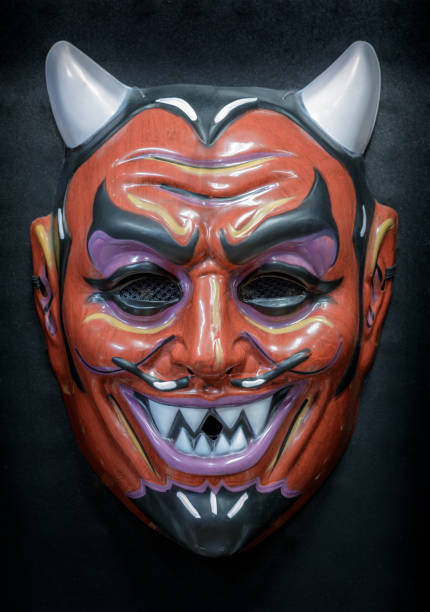 istock Vintage Devil Face Mask Isolated Against Black Background 1282765433