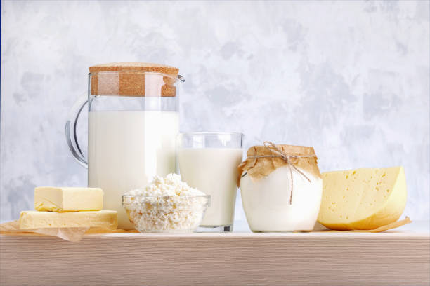 istock Fresh dairy products on wooden shelf against grey background. 1282769433