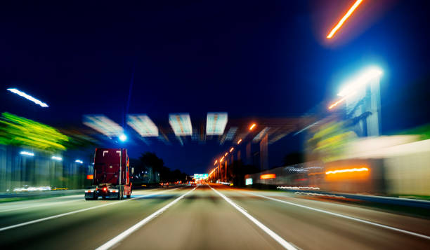 istock Truck speeding in Miami at night on an empty highway 1282771051