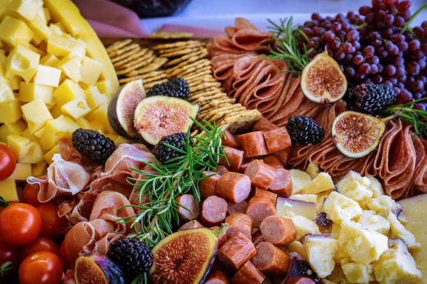 istock Cheese, fig, and crackers on charcuterie board . 1282772271