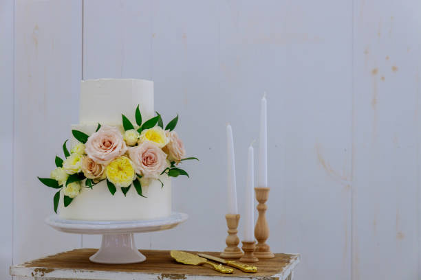 istock White wedding cake with fresh flowers and candles. 1282772273