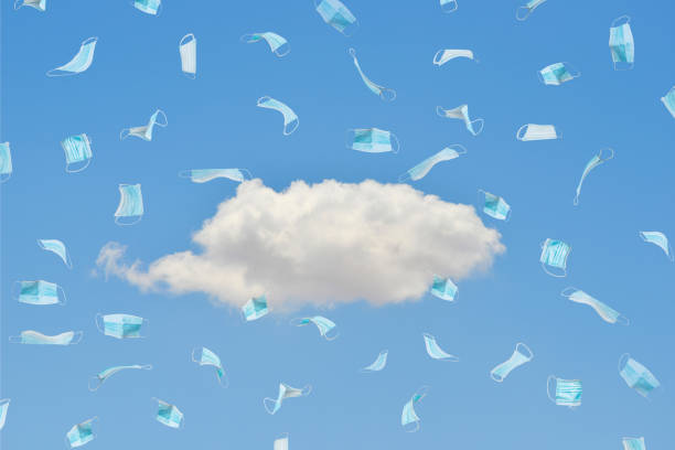 istock A medical mask under a blue sky and white clouds 1282774271