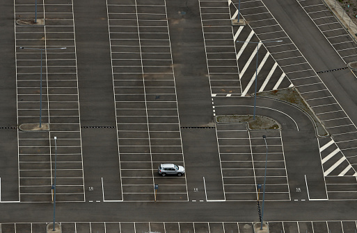 A lone vehicle in a parking lot