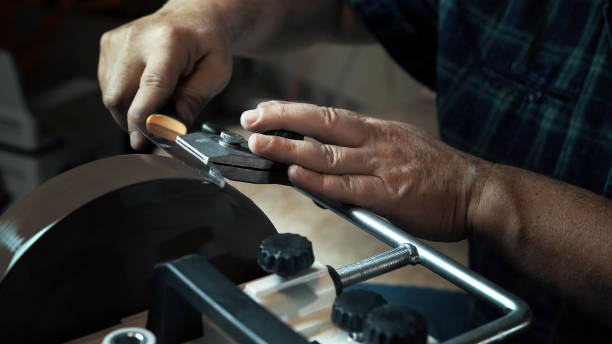 Man sharpens knives on a grinder. Close up hand Man sharpens knives on a grinder. Close up. sharpening photos stock pictures, royalty-free photos & images