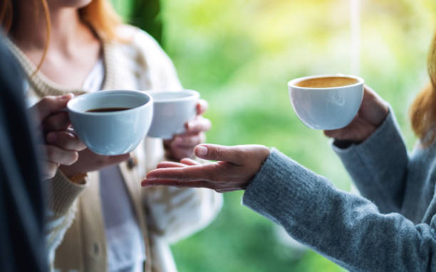 istock people enjoyed talking and drinking coffee together 1282778757