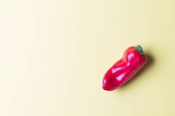 istock Onne ripe red bell pepper on a bright yellow background. Copy space 1282780117