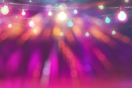 abstract blurred of colourful glittering light bulb background in festival party