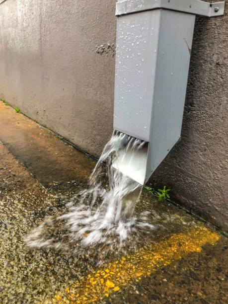 istock Storm Water Coming out of Rain Gutter 1282791167