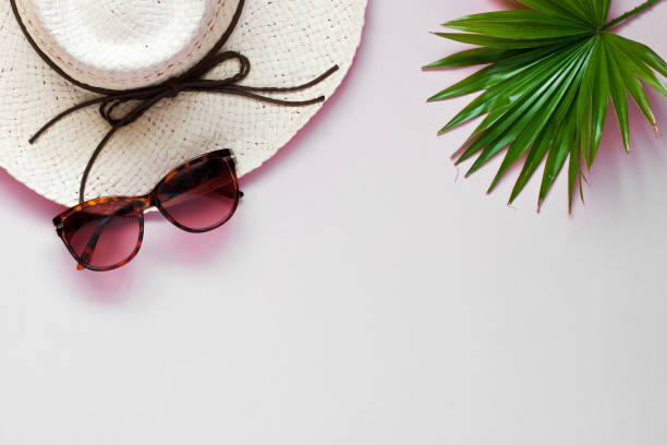 istock Sunglasses and wicker hat on color background 1282792017