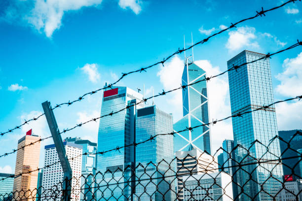 istock Cityscape outside barbed wire fence 1282793131