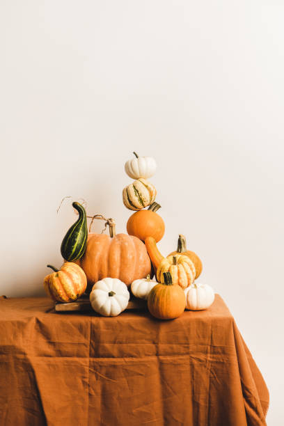 istock Colorful pumpkins for holiday decoration in pyramid composition on table 1282793888