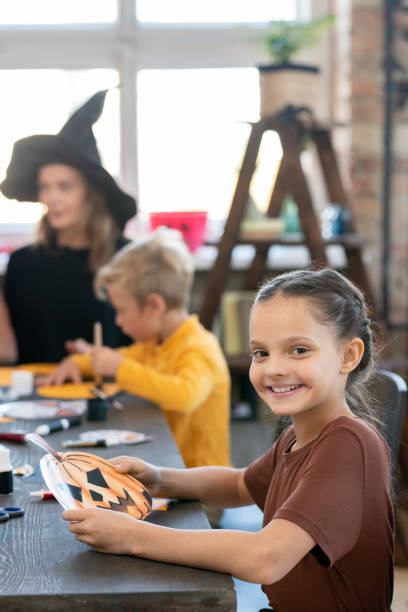 istock Pretty girl making Halloween pumpkin craft 1282796910