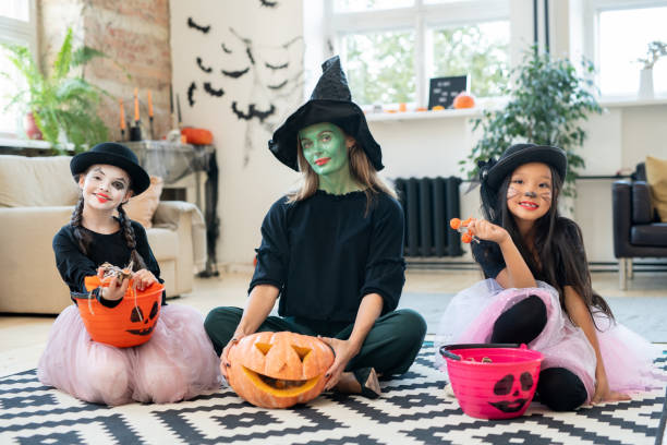 istock Three pretty witches at Halloween party 1282797568