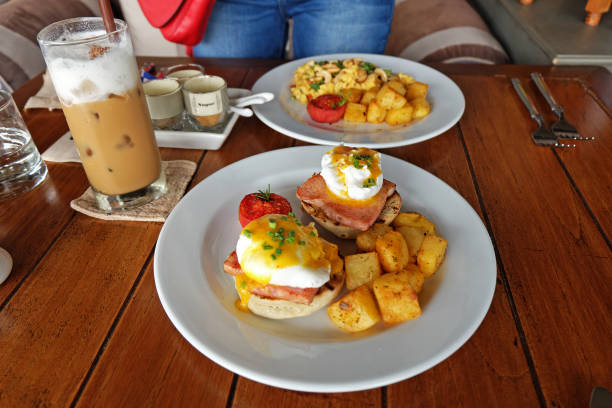 istock Scrambled and eggs benedict served with grilled potatoes and coffee 1282801920