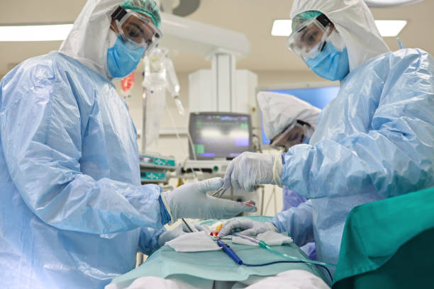 istock Doctors and Nurses in Surgery During Time of COVID-19 1282801939