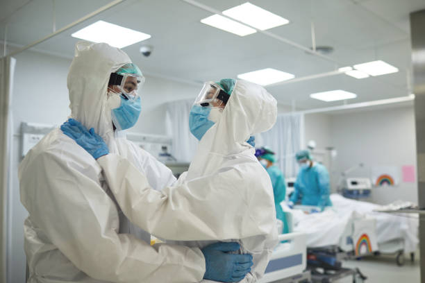 istock Hospital Staff Exchanging Support in Time of COVID-19 1282801943