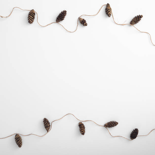 istock Zero waste christmas garland made from pine cone and natural jute twine. Horizontal composition, flat lay, top view. Eco friendly mockup with garland ornament 1282802719
