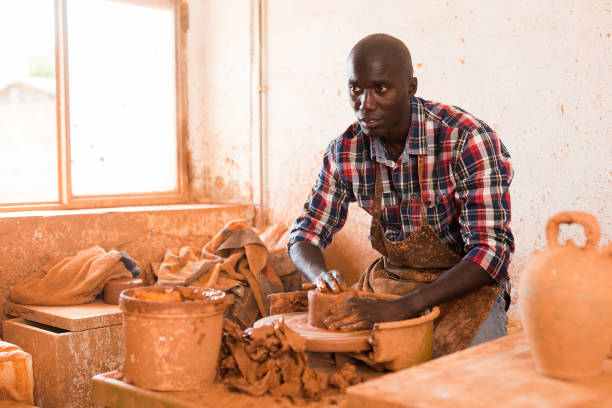 istock Craftsman woring with clay on potter wheel 1282802753