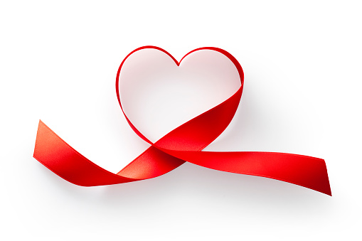 Red ribbon wrapped in the shape of a heart isolated on white background.