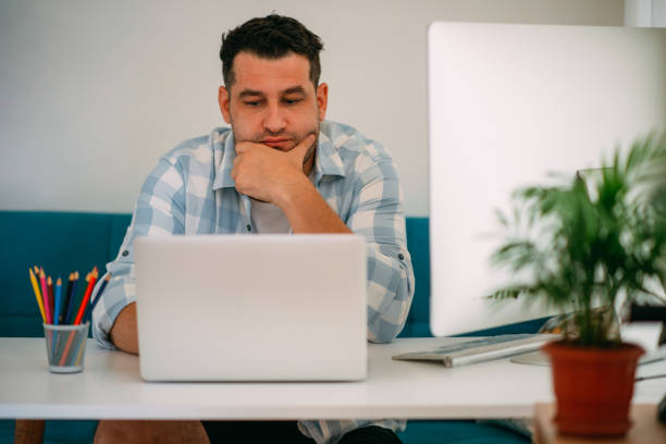 istock Depressed Man Working With Laptop at Home 1282803549