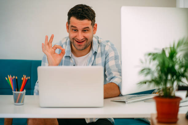 istock Handsome Man Showing Ok Sign When Making Video Conference 1282803675
