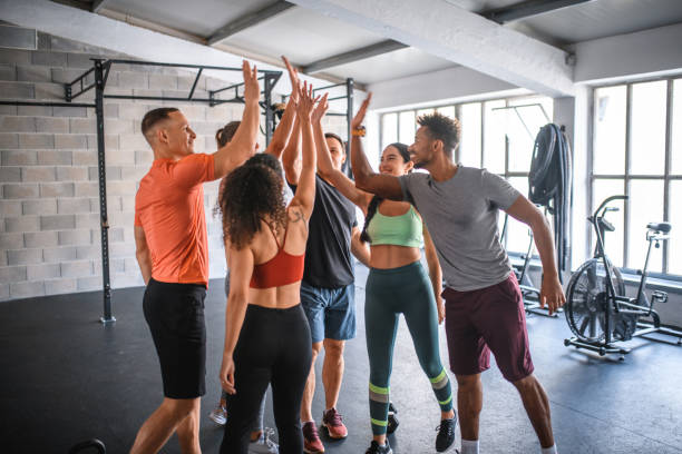 istock Supportive Exercise Friends High-Fiving After Workout at Gym 1282804470