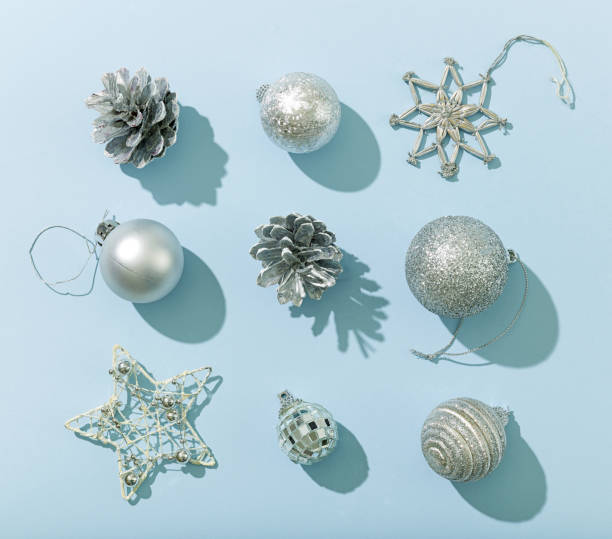 istock various silver color christmas decorations on blue paper background 1282804777