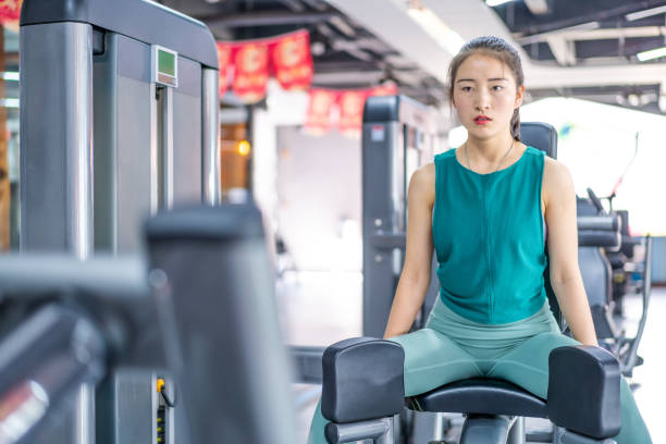 istock Young Asian female strength training in the gym 1282805697