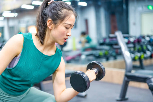 istock Young Asian female strength training in the gym 1282805939
