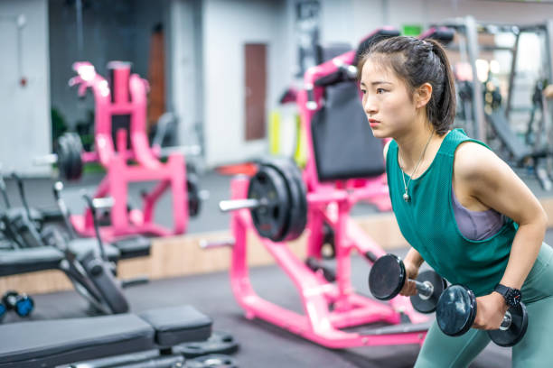 istock Young Asian female strength training in the gym 1282806739