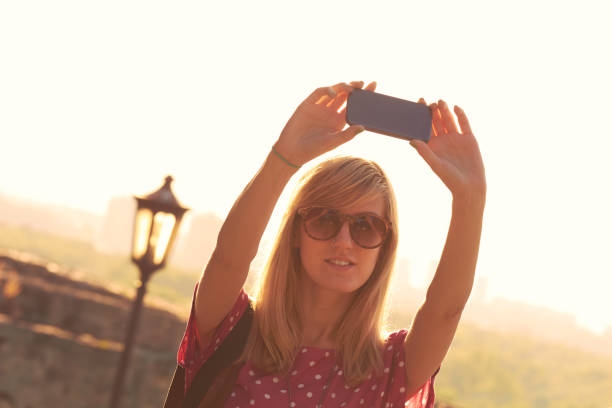istock Young woman using modern smartphone in urban surroundings. 1282807183