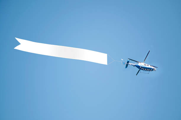 Helicopter with banner Helicopter with banner against clear sky words in the sky stock pictures, royalty-free photos & images