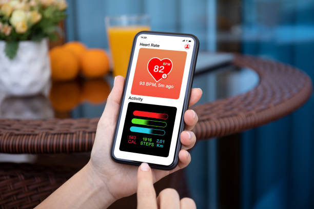 istock female hands holding phone with application heart and activity 1282809750