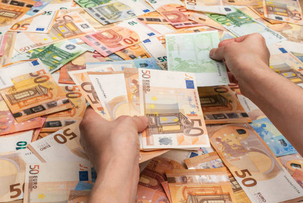 istock Hands counting bills of five, twenty, 50 and 100 euros 1282810064