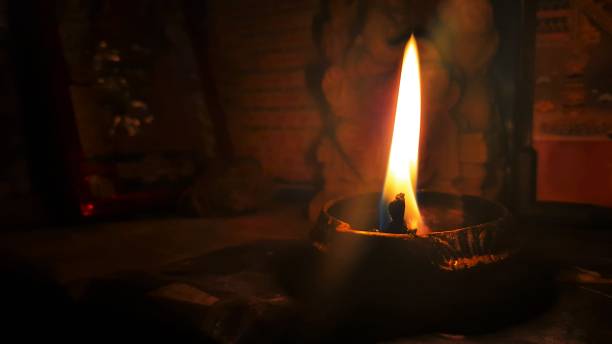 istock lighten metal lamp glowing flame in dark background 1282810621