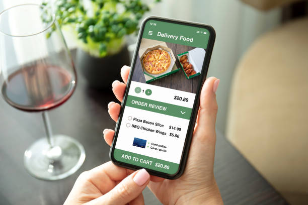istock female hands holding phone with food delivery application on screen 1282810719