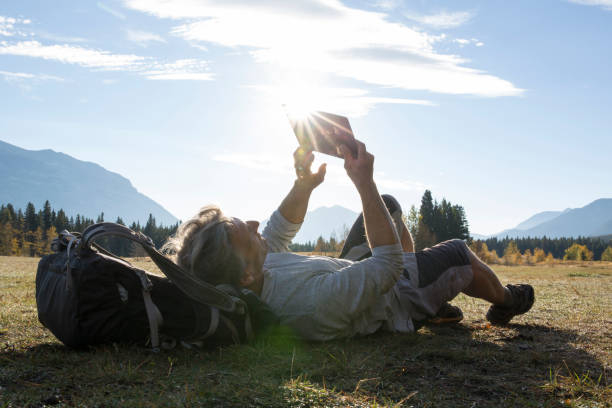 istock Hiker relaxes in grassy meadow at sunrise 1282810853