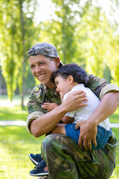 istock Joyful military dad holding little son in arms 1282811160