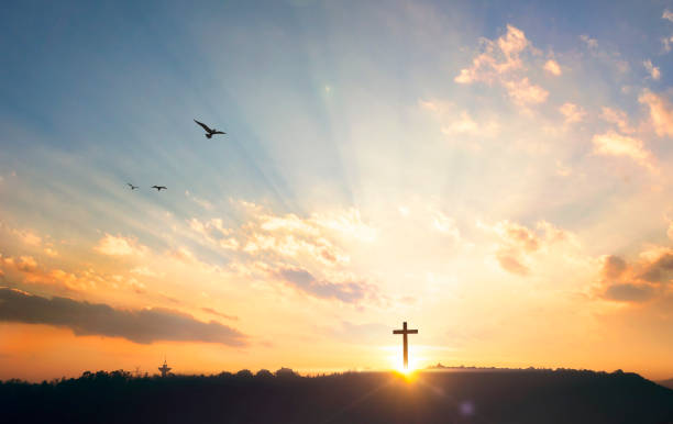 istock Religious concept: Silhouette cross on mountain at sunset background 1282813842