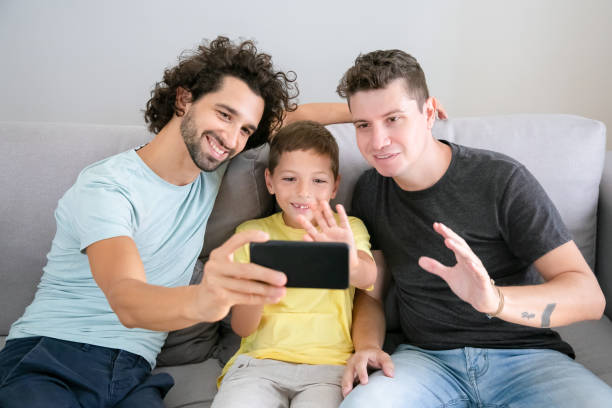 istock Happy gay parents and kid using cellphone for video call 1282814006